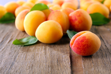 Fototapeta na wymiar Ripe apricots on wooden table, closeup