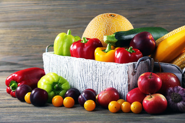 Heap of fresh fruits and vegetables on wooden background