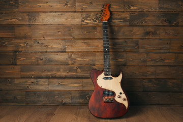 Electric guitar on wooden background