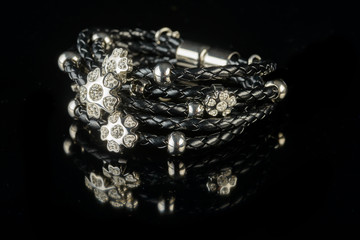 jewelry and bracelets on a black background
