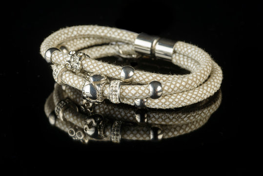 jewelry and bracelets on a black background
