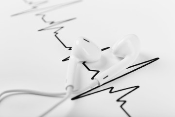 Earphones on cardiogram background