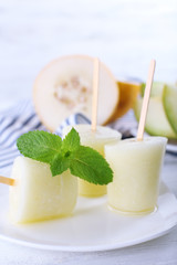 Melon ice lolly on table, closeup