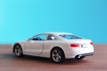 Small toy car on blue background