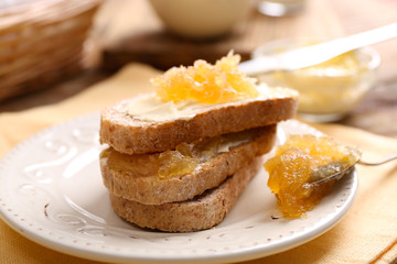 Fresh toast with butter and jam on table close up