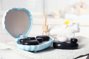 Spa stones and spa treatments on light background