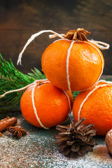 Fototapeta na wymiar Tangerines and fir-cone as the Christmas Decor.