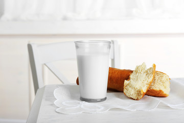 Milk with bread on table in kitchen