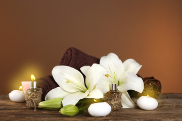 Beautiful spa composition with lily on brown background