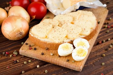 Bread with butter and slices of romadur cheese and eggs