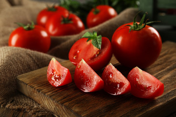 Red tomatoes on cutting board closeup