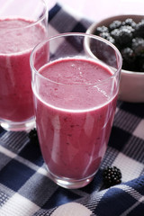 Delicious berry smoothie with blackberries on table close up