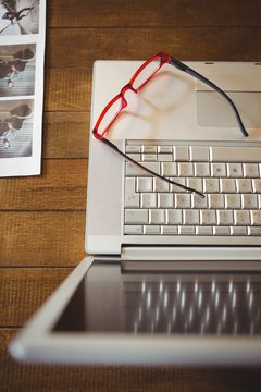 Eye glasses on laptop at creative office