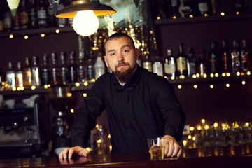 Portrait of handsome bartender at  work