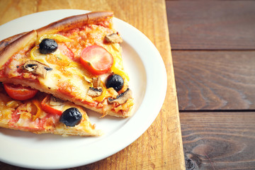 Sliced pizza on cutting board