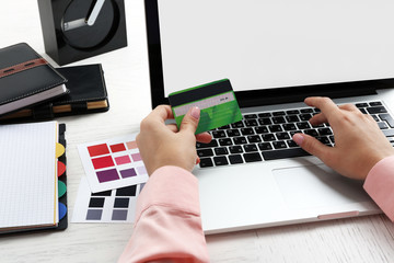 Fototapeta na wymiar Concept for Internet shopping: hands with laptop and credit card