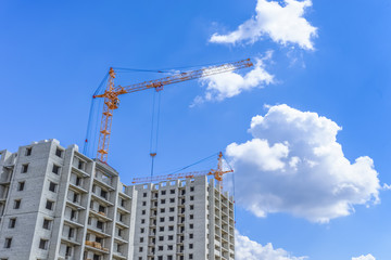 Fototapeta na wymiar Building of new houses and hoist crane