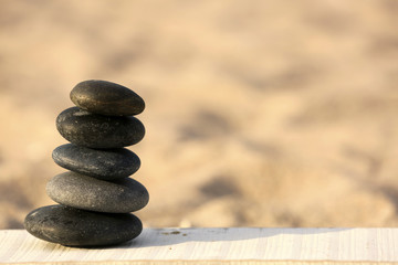 Spa stones on sand beach close up