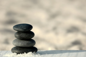 Spa stones on sand beach close up