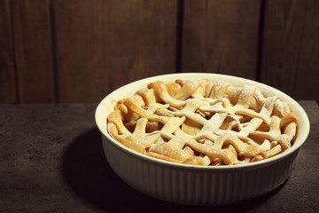 Homemade apple pie on wooden background