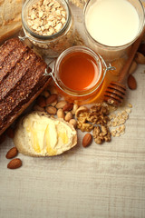 Fototapeta na wymiar Healthy breakfast with bread, honey, nuts. Country breakfast concept