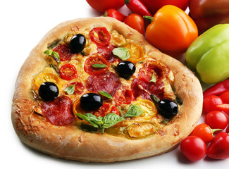 Heart shaped pizza and fresh vegetables closeup