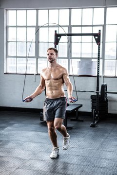 Fit man using skipping rope