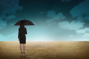 Business Person Hold Umbrella On Desert