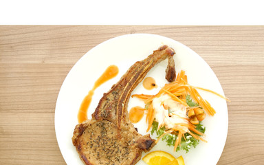 grilled pork chop steak. Colorful salad and orange sauce