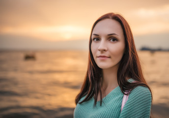Portrait of a beautiful young woman at sunset.