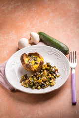 little cake with eggs mushroom and zucchinis