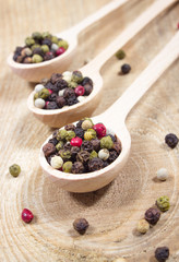 Color pepper on a wooden background.