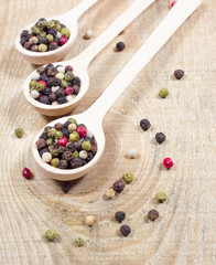 Color pepper on a wooden background.