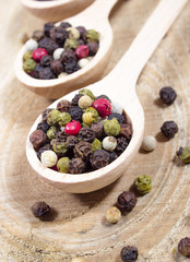 Color pepper on a wooden background.