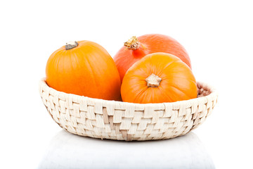 yellow pumpkins vegetables in basket, isolated on white backgrou