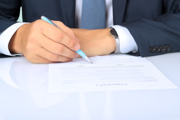 Businessman is signing a contract, business contract details