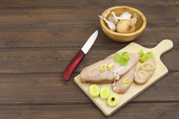 Preparing Diet food. Fresh raw chicken fillet and vegetables prepared for cooking. Fresh raw chicken breasts. Preparing chicken at a summer barbecue. Cooking with fresh dietary ingredients.
