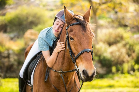 Happy woman riding her horse