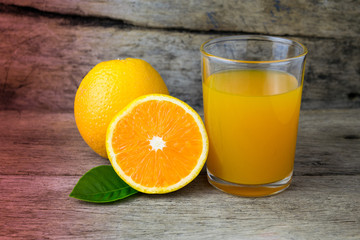 Glass of orange juice on wooden table, fresh drink