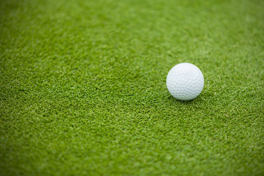 Golf ball on the green lawn