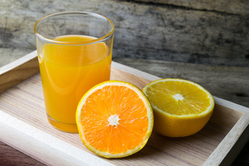 Fototapeta na wymiar Glass of orange juice on wooden table, fresh drink