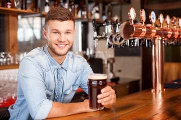 Handsome male bartender is working in bar