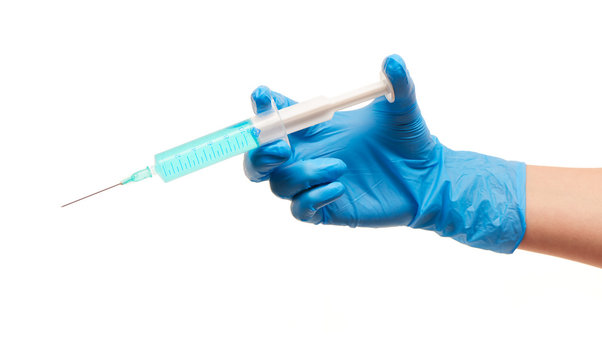 Close up of female doctor's hand in blue sterilized surgical glove with plastic medical syringe filled with blue drug against white background - Powered by Adobe