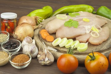 Preparing Diet food. Fresh raw chicken fillet and vegetables prepared for cooking. Fresh raw chicken breasts. Preparing chicken at a summer barbecue. Cooking with fresh dietary ingredients.
