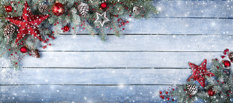 Christmas Fir Tree On Wooden Background With Snowflakes
