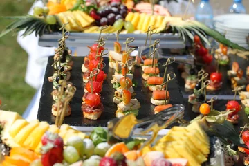  meat, fish, vegetable canapés on a festive wedding table outdoor © Elroi