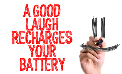 Hand with marker writing: A Good Laugh Recharges Your Battery