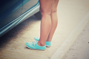 Woman with sneaker and car on the road