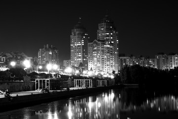 Lights night city with reflections on the river black and white