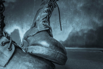 Combat boot on wooden